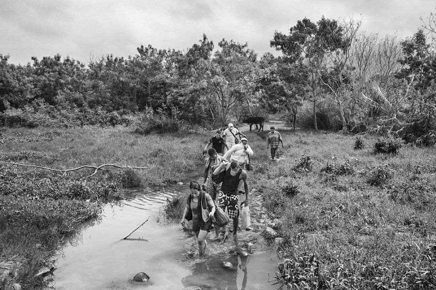 People follow a path to enter Colombia illegally, near Villa del Rosario in North Santander, Colombia, one of the busiest regions for border crossings.