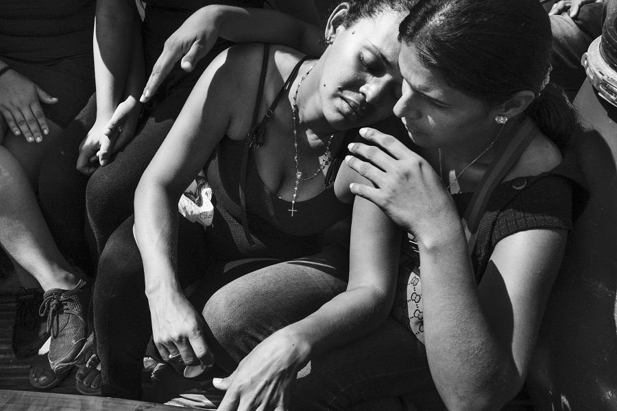 Women mourn a Venezuelan migrant who died in Riohacha, Colombia.