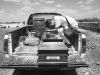 Luis Arevalo, a migrant from Venezuela, sits in the back of a pickup truck mourning his sister Luisana, in Riohacha, Co- lombia.