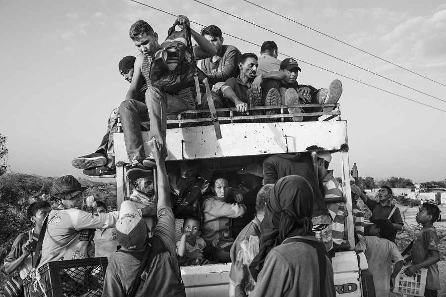 Migrants crowd onto a truck near the Colombia-Venezuela border, in La Guajira, Colombia.