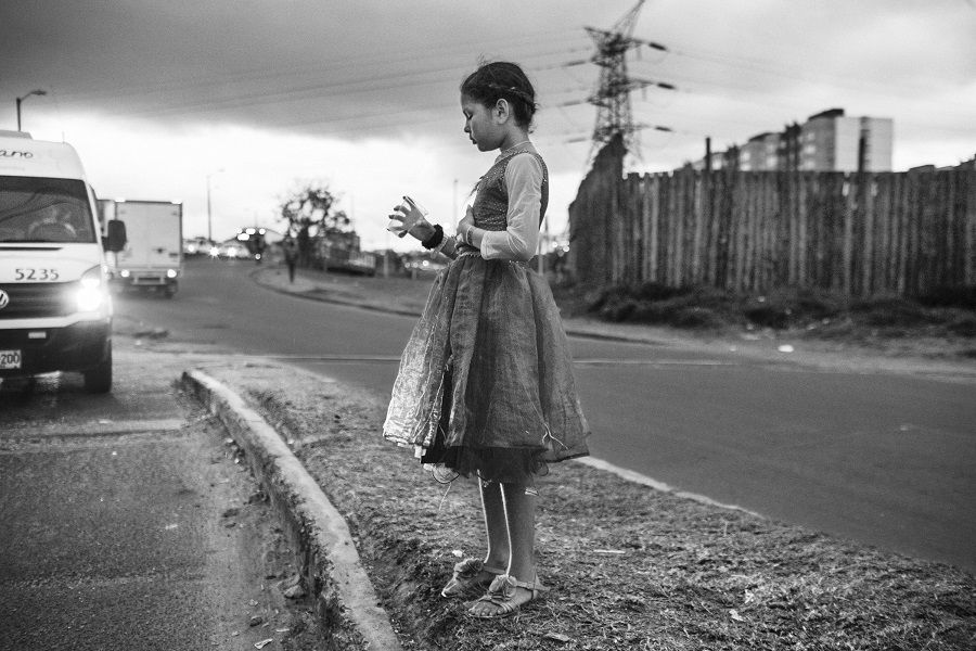 A young girl asks for money on a street in the Colombian capital, Bogotá. By June 2019, the Colombian Institute of Fa- mily Welfare (ICBF) had provided attention to nearly 80,000 Venezuelan children, adolescents and families countrywide.